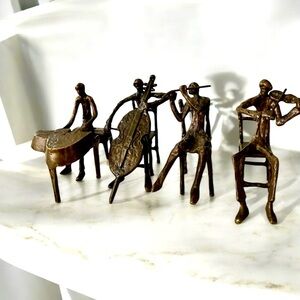 Alfonso Burn (b. 1942) Four-piece set of bronze musicians sculptures.